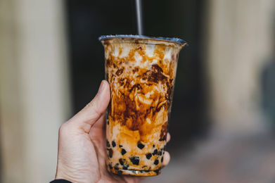 Hand holding a brown sugar bubble tea