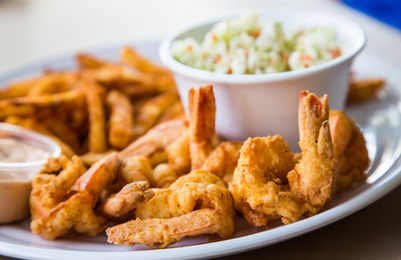 Fried shrimp, fries, and coleslaw