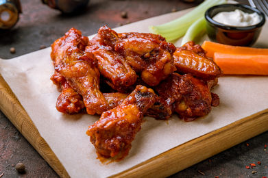 Chicken wings with celery, carrots, and dipping sauce